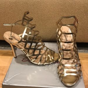 Gold cage faux leather stiletto sandals.